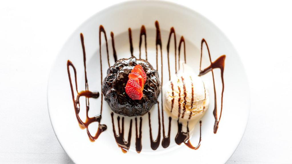 Chocolate Lava Cake (Petit Gâteau) · Molten cake topped with vanilla ice cream and chocolate syrup.
