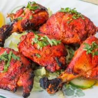 Tandoori Chicken · Bone in chicken baked in tandoor marinated with yogurt and special blend of spices