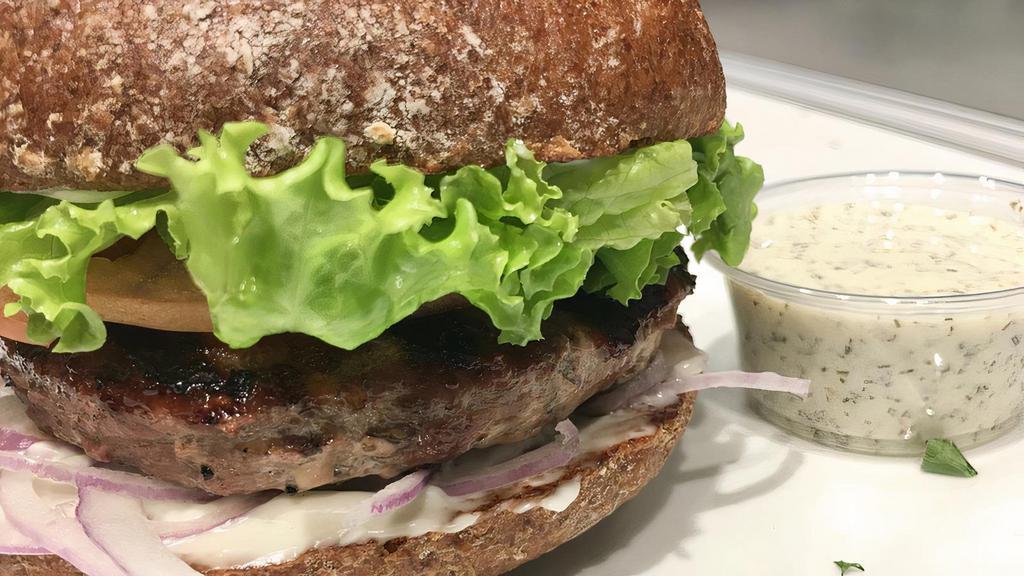 Lamb Burger · Organic New Zealand lamb with garlic mixed in, then grilled with swiss melted over & served with lettuce, tomato &  red onion on a house baked WW bun. 
Served with house made tzatzaiki sauce. 
GF bun upgrade available