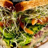 Veggie Sandwich · WHOLE Veggie Sandwich with kalamatas, tomato, hummus, cucumber, pickles, red onion, Veganais...