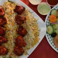 Chicken Tikka Platter · Chicken Cubes perfectly Barbecue in Tandoor (Clay Oven). 2 Skewers  with Rice and Salad.