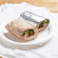 Turkey Club Wrap · Roasted turkey, bacon, Provolone, tomatoes, romaine and mayonnaise in a honey wheat tortilla.