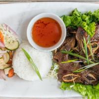 C-16. Kalbi · Tender beef short ribs marinated in a sweet sesame soy sauce grilled to perfection, served w...