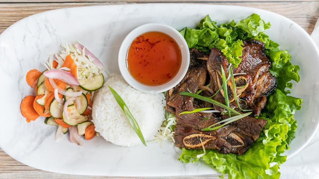 C-16. Kalbi · Tender beef short ribs marinated in a sweet sesame soy sauce grilled to perfection, served with cucumber salad.