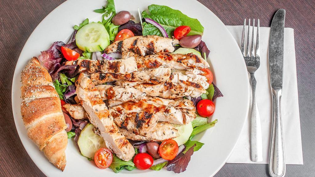 Grilled Chicken Salad · Our garden salad topped with fresh marinated grilled chicken. Served with our garlic bread sticks, baked on the premises daily.