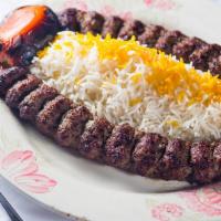 #16. Kabob-E-Kubideh · Two skewers of ground beef cooked over open fire.