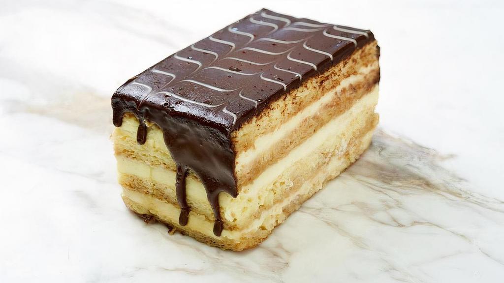 Boston Cream Pie Slice · layers of coffee soaked vanilla sponge cake with vanilla pastry cream all covered in chocolate ganache