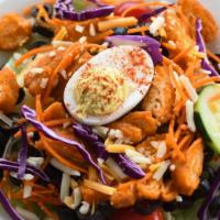 Buffalo Chicken Salad · Garden salad topped with eggs and chicken tenders tossed in our homemade hot sauce.