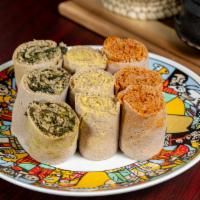 Vegan Rolls (9) · Yellow split peas, red lentils, and spinach rolled in injera.