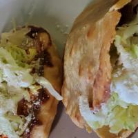 6# Combo · Two gorditas and one sope with chicken, beans, lettuce, cheese and sour cream.