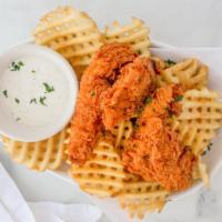 House Chicken Strips · Hand battered crispy-fried chicken breast tenders served with waffle fries and dipping sauce.