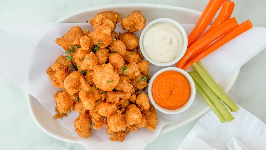 Buffalo Cauliflower · Vegan. Cajun battered fresh cauliflower drizzled with Myrna's spicy buffalo sauce, served with carrot, celery sticks, and ranch dipping.
