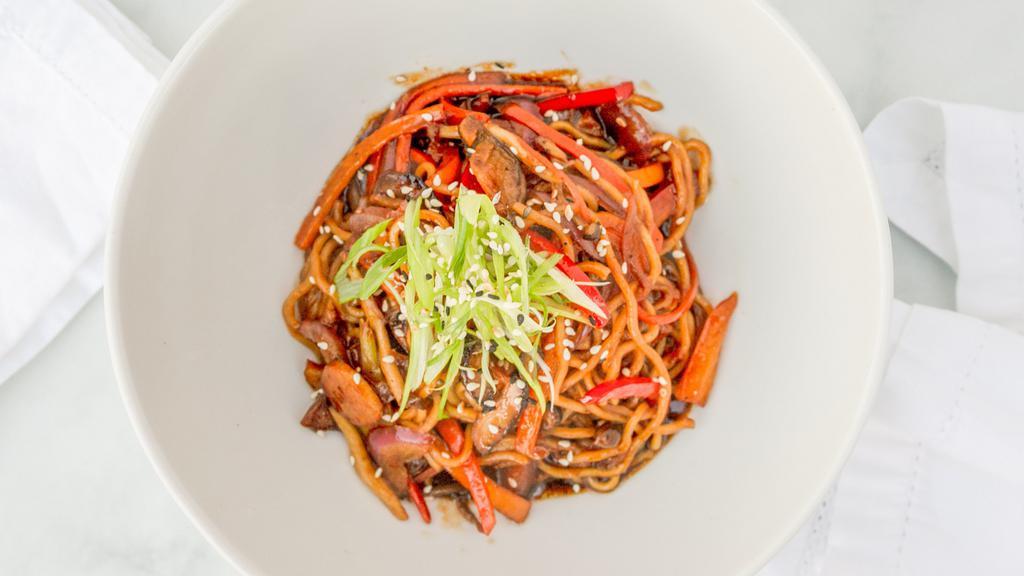 Soba Noodle Bowl · Vegetarian. Yakisoba noodles in our house ginger-soy sauce, stir-fried with celery, carrot, onion, bell pepper, and mushroom. Finished with scallions and sesame seeds.