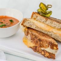 Glamorous Grilled Cheese · Thick sliced five-grain bread overflowing with sharp cheddar and swiss cheese served with to...