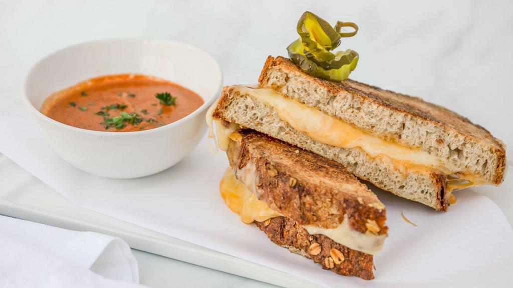 Glamorous Grilled Cheese · Thick sliced five-grain bread overflowing with sharp cheddar and swiss cheese served with tomato bisque dipping sauce.