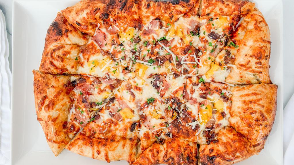The Hula · Ham, pineapple, and bacon with our house red sauce, and three cheese blend.