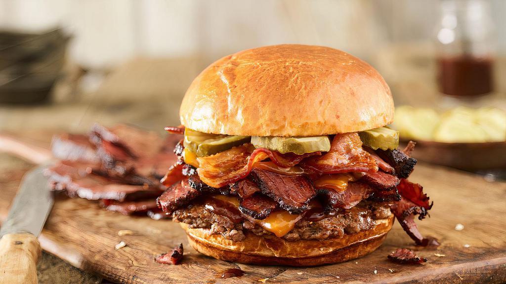 Smoked Bacon Brisket Burger · Certified Angus Beef, smoked aged cheddar cheese, brisket, applewood smoked bacon, pickles, bbq sauce, toasted brioche bun