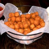 Sweet Potato Tots · Lightly Seasoned with a side of roasted garlic aioli and harissa ketchup