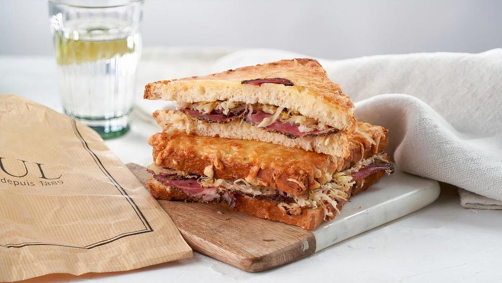 Croque Reuben · Peppered beef pastrami, Ssuerkraut, mustard, and melted swiss cheese between two crispy slices of bread topped with butter. Served with a side salad.