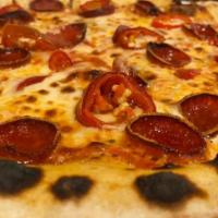 La Diavola Pizza · Tomato passata, mozzarella, spicy soppressata salame, Calabrian chili oil.