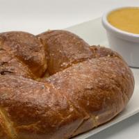 Pretzel With Cheese · Soft baked pretzel brushed with hot garlic parmesan butter and served with house-made beer c...