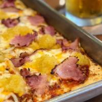Hawaiian Flatbread Pizza · Thin flatbread covered in mozzarella, cheddar, provolone. With applewood ham and pineapple.