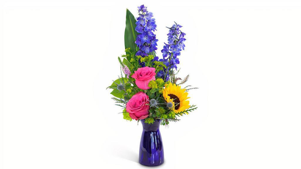 Weekend Vibe · Feel the weekend vibes with a flower arrangement chock-full of fun, energy, and elegance! Weekend Vibe features blue delphinium, adorable and energetic pink roses, a sassy sunflower, all surrounded by lushes foliage in a cobalt blue glass vase. Nothing gets someone feeling the weekend vibe like this flower bouquet! Send flowers like Weekend Vibe for any occasion, any day.     

Approximately 8