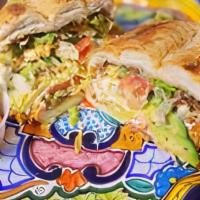 Torta De Tinga De Pollo · Mexican sandwich with tinga chicken, chipotle mayo, refried beans, avocado, jalapeno, onion,...