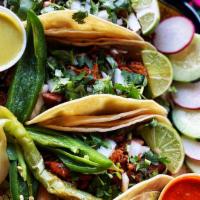 Chileajo Guajillo Tacos · your choice of carnitas, steak or chicken. 3 tacos with flour or corn tortillas. served with...