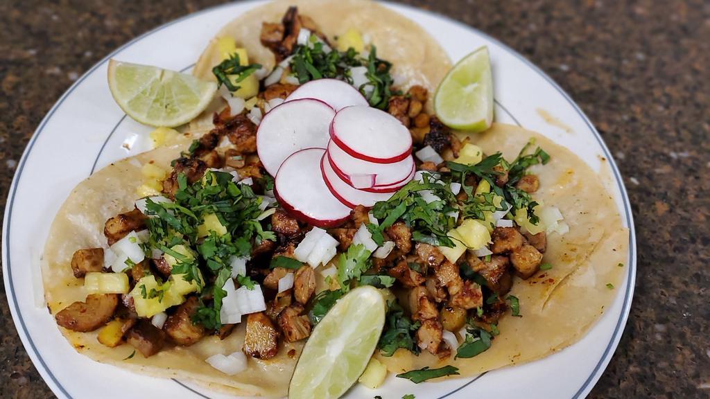 Al Pastor · Thinly sliced pieces of marinated pork cooked with pineapple.