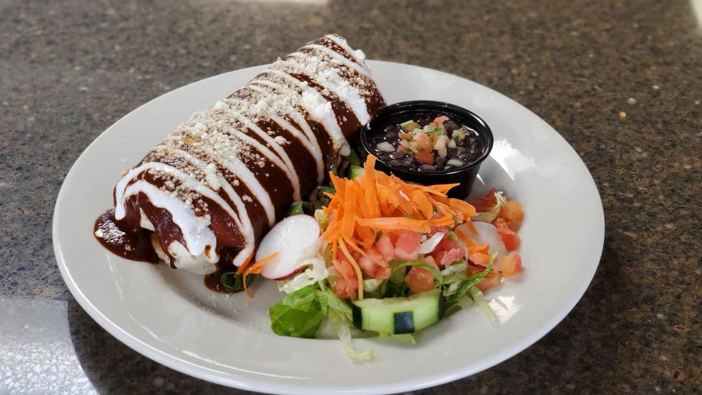 Famous Wet Burrito · Your choice of chicken or beef, topped with traditional mole sauce, mexican sour cream and queso fresco.