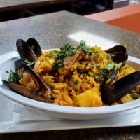 Traditional Paella · A Spanish background dish. Consists of rice mixed with small pieces of shellfish, chicken, s...