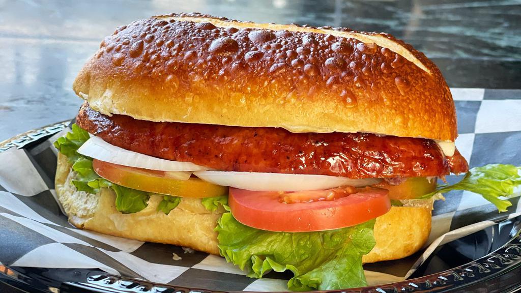 Sausage Oktoberfest Sandwich · Your choice of Sausage.
Organic tomato, Organic lettuce, organic Onion and Organic Swiss cheese on a laugen broetchen (pretzel bun) 
Your choice of sauce; Spicy chilli mustard, Mayo or brown Dijon mustard.
Extra sauce on side is optional