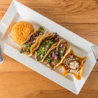 Tacos: Carnitas · Slow-cooked pork in beer and citrus marinade. Onion, cilantro.