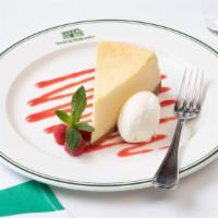 New York Style Cheesecake · Creamy and traditional New York style cheesecake with a sweet graham cracker crust, served w...