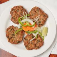 Chicken Chapli Kabab · Chicken cooked with spinach and exotic spices garnished with fresh coriander.