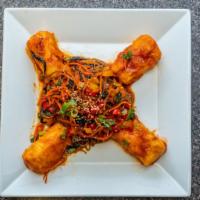Yang Nyum Tofu · deep fried tofu marinated in a spicy red soybean sauce & served w/ carrots, peas, onion & sp...