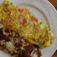 Veggie Omelette · With broccoli, spinach, roasted red peppers, asparagus, onions, and tomatoes. Served with ho...