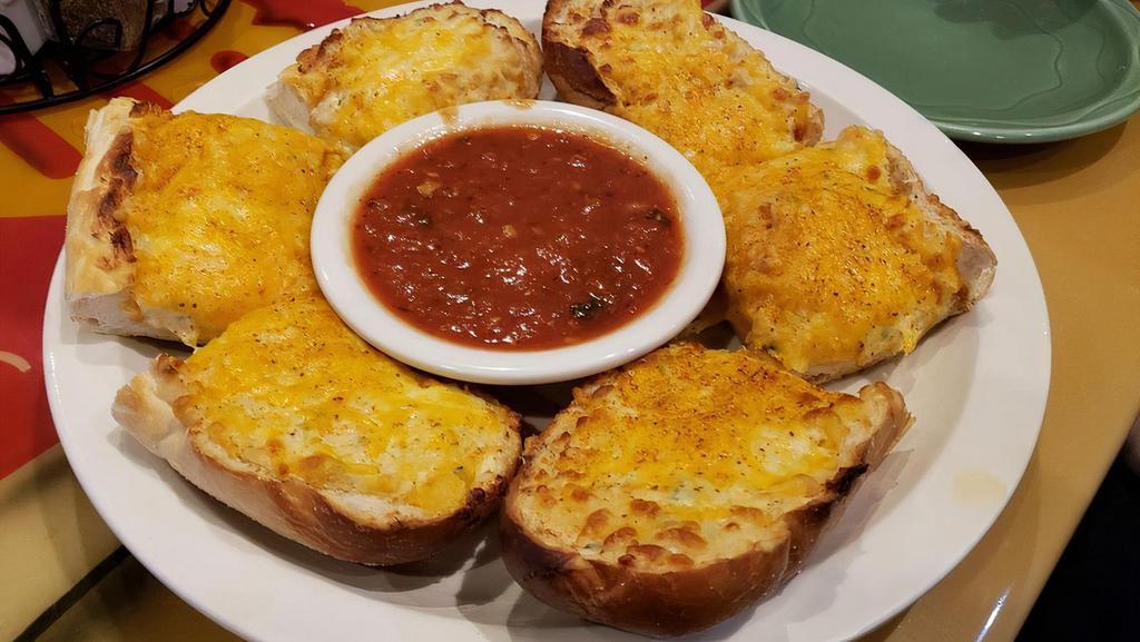 Homemade Crab Bread · Italian bread layered with crab salad and a blend of cheeses, then baked, dusted with old bay, and served with marinara.