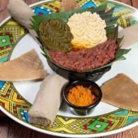 *18. Shalla Special Kitfo · Buttered lean beef mixed with mitmita served with buttered homemade cheese, gomen and Kotcho.