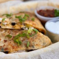 Barbecue Chicken Quesadilla · Charcoal-grilled chicken, black beans, corn, onions, red peppers & cheese. Served with sour ...