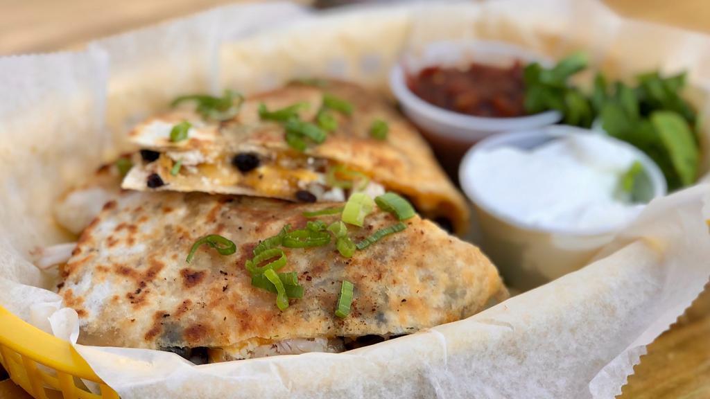 Barbecue Chicken Quesadilla · Charcoal-grilled chicken, black beans, corn, onions, red peppers & cheese. Served with sour cream and salsa.