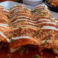 Pollo Enchiladas · Three corn tortillas filled with pulled chicken and cheddar cheese topped with guajillo sals...
