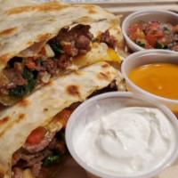 Steak Quesadilla · Sliced flank steak, roasted pablanos, corn, garlic, sauteed spinach, roasted red peppers, an...