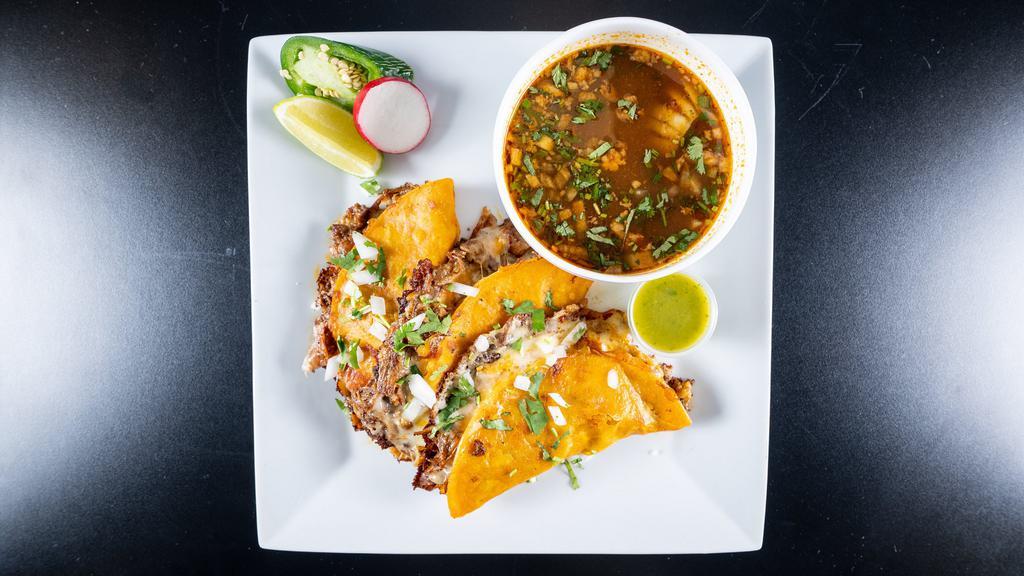 Birria Tacos (3) · Marinated slow cooked beef short rib, ribeye in spiced adobo broth, tucked in grilled adobo coated corn tortillas with melted three cheese blend, raw onions. and cilantro. Rich consomme on the side for dipping.