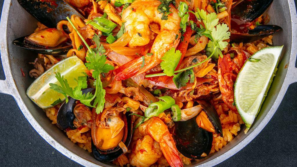 Paella Del Mar · Shrimp, calamari, clams, mussels, olive oil, garlic, white wine, roasted onions, scallions, peppers and saffron over Spanish rice.