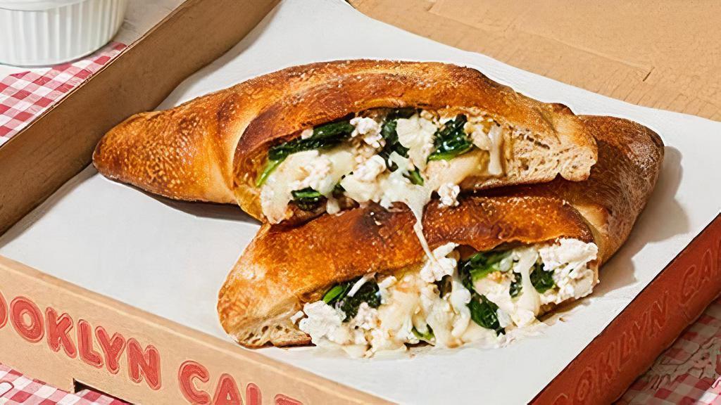 Greenpoint Calzone · Calzone with fresh spinach, garlic, burrata, melted mozzarella, and a side of marinara. (v)