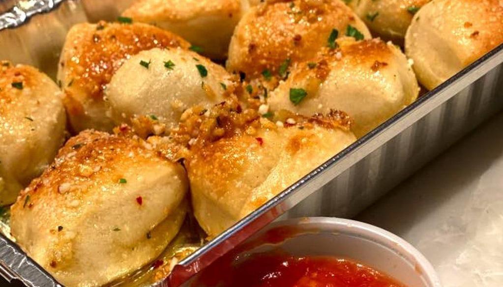 Garlic Knots · Fresh-baked with olive oil, fresh garlic, parsley & cheese, served with tomato sauce side