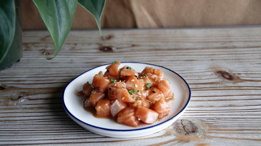 Salmon Poke ($20/Lb) · Raw chunks of fresh Atlantic Salmon, dressed with your choice of house-made sauces: soy-ginger sesame dressing (pictured) or spicy mayo.