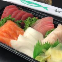 Sashimi Deluxe · 25 pieces assorted fish with a bowl of sushi rice. Served with miso soup, and salad.